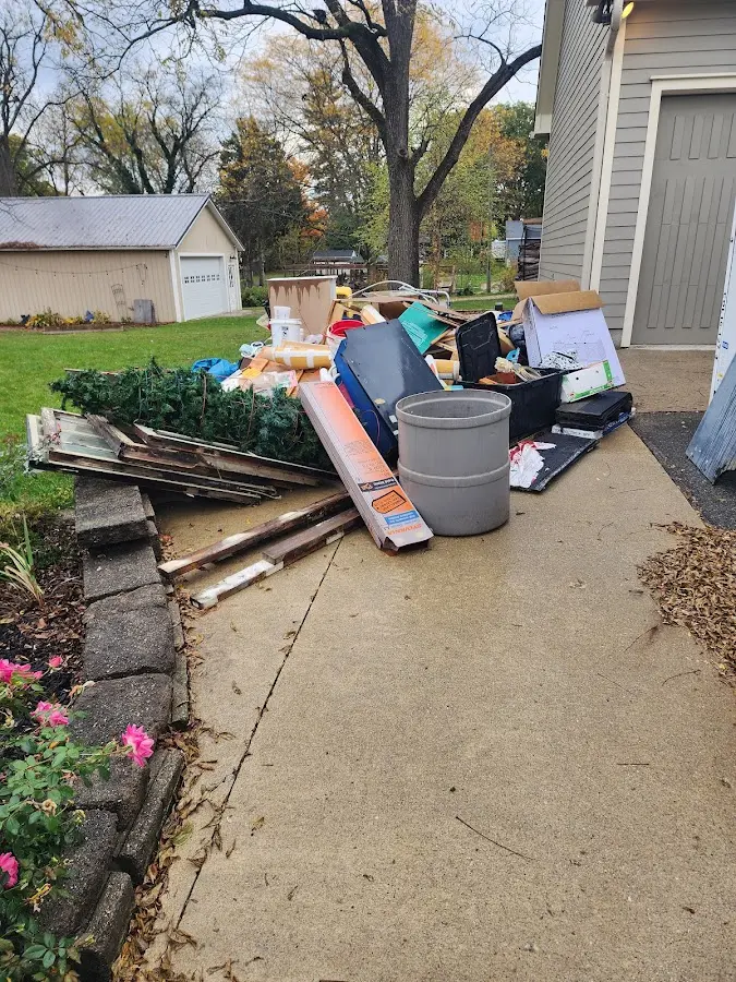 Dumpster being loaded with debris for 12 Yard Dumpster Rental in Hardwick